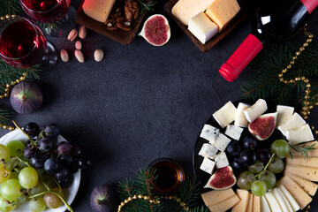 Frame made from varieties of cheese, fruits and nuts on dark background. New Year's Eve Party Snack