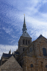 Fototapeta na wymiar View on the abbey church tower in front of blue sky. Mont Saint Michel / Normandy / France