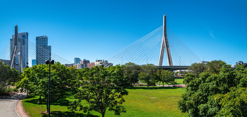 Paul Revere Landing Park green meadow landscape with the view of Zakim Bridge and downtown buildings in Boston