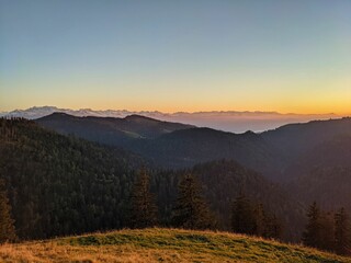 beautiful autumn sunset. Schnebelhorn, Zurich. The rays of the sun illuminate the meadow and the trees. view of the alps