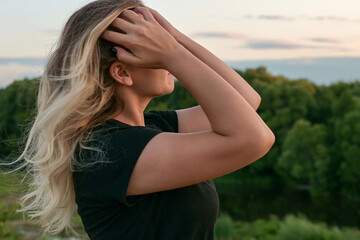 portrait of a beautiful European girl with loose hair against the background of nature