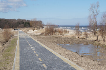 Construction of a bicycle lane. Bicycle lane along the sea. Unfinished pedestrian road. New bicycle lane made of sidewalk tiles.