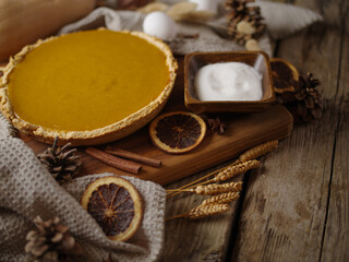 Thanksgiving day background. Traditional American pumpkin pie, ingredients, decor, kitchen utensils. No people. Low angle view. Pastel shades. A restaurant. hotel. a cafe. home kitchen.