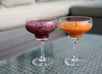 Healthy and delicious colorful homemade smoothies served in fancy drink glasses.