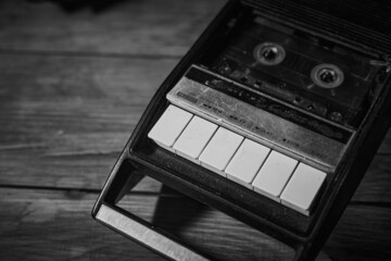 Old vintage cassette recorder on a desk, cinematic noir scene