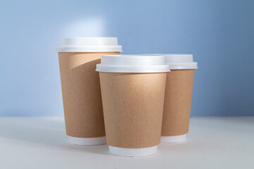 empty mock up  paper cup to go against light blue background