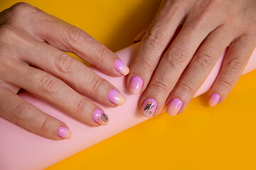 Fototapeta premium female hand beautiful manicure on color background