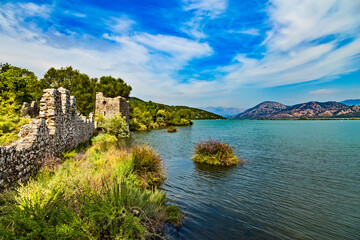 Fototapeta na wymiar Butrint lake salt lagoon, beautiful summer view from Butrint National Park, the famous UNESCO World Heritage Site in Albania, archeological site in Ksamil not far from Sarande on the south of Albania.