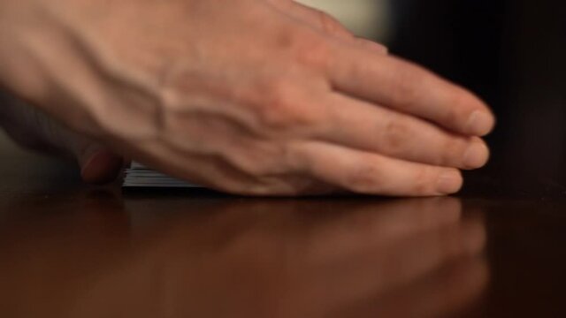 Female hands collect Tarot cards in a pile