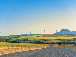 Colourful rolling hills and wind turbine in the overberg valley in western cape South Africa
