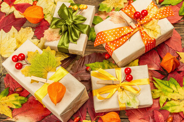 Zero waste gift concept with autumn design. Warm sweaters, fall leaves, thematic decor