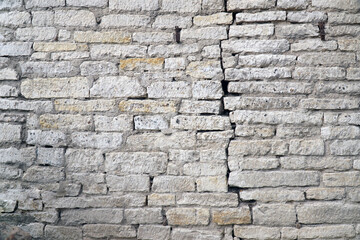 crack in the brick wall of white gray brick