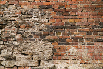 old brick wall of red brick and stone