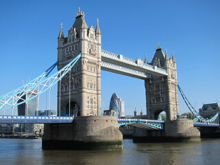 Fototapeta na wymiar The tower bridge in London. Brightly lit in blue sky