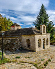 Obraz premium The picturesque moni Rogovouduring fall season the stone build church is located near tsepelovo aboves vikos gorge on Tymfi mounain t, Zagori, Epirus, Greece. 