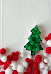 christmas tree with red and white pom poms