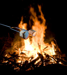 Pair of marshmallows near an open fire