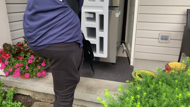 refrigerator being delivered to a house
