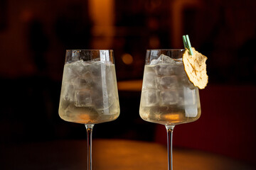 Fashionable transparent cocktails in soft muffled light, social media minimalist shot