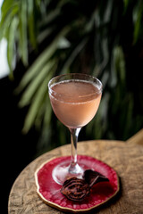 Small aperitif cocktail in blurred lights of dark empty bar