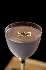 Close up photo of expensive fashionable cocktail with edible gold on top