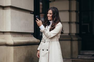 Beautiful young woman using a smartphone while out in the city