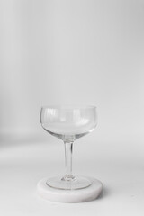 Empty coupe glass on marble coaster