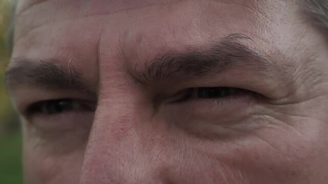 A man with angry eyes. The concept of anger and hatred. Soft cinematic focus