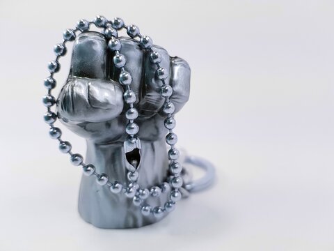 Symbolic picture, metal fist placed in chains 
