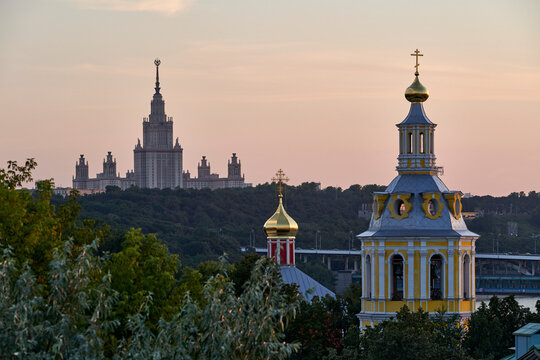 Russia. Moscow at sunset. The main building of Moscow State University, the Church of the Ascension and the Church of St. John the Theologian in the Andreevsky Monastery