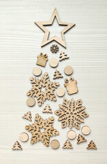 Christmas tree made from winter wooden elements on a wood white table.