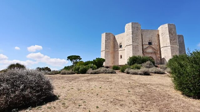 Andria, Puglia, Italy. August 2021. POV footage walking around Castel del Monte. On a magnificent summer day with clear skies, the fort dominates the scene.