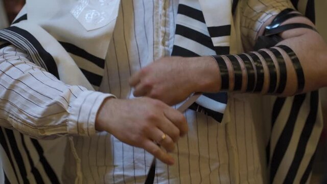 An adult male, a Jew, puts on tefillin