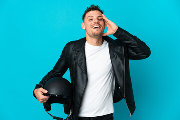 Naklejka premium Caucasian man with a motorcycle helmet isolated on blue background with surprise expression