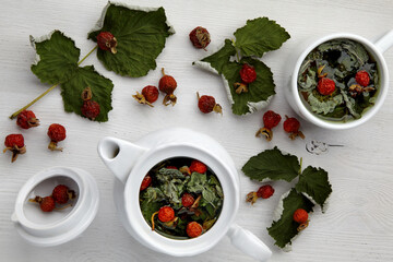 Warming medicinal herbal tea with roseberries and currant leaves