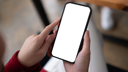 Closeup executive business woman using smartphone at her working desk in office, smartphone blank...