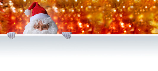 adult santa claus with white beard holds a white poster, blank for a designer for a postcard,...