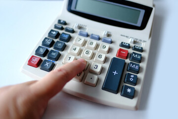 closeup keys and display of the calculator, female hand presses the buttons of the stationary Cash...