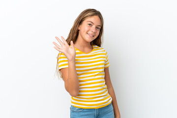 Little caucasian girl isolated on white background saluting with hand with happy expression