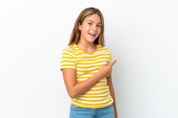 Little caucasian girl isolated on white background surprised and pointing side