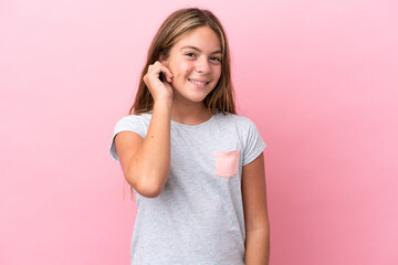 Little caucasian girl isolated on pink background laughing