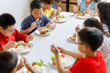 Group Of Children Eating Lunch In School