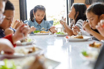 Group Of Children Eating Lunch In School
