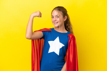 Super Hero little girl isolated on yellow background doing strong gesture