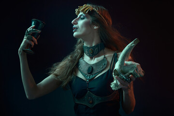 Dark sorceress casting a magic spell with an animal skull