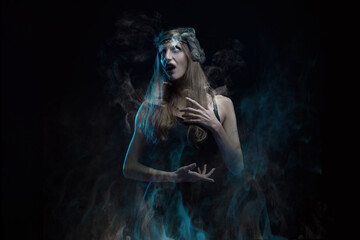 Burning vampire or witch woman, screaming in agony, drowning in flames, dark halloween concept