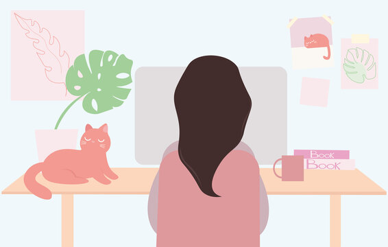 a young woman is sitting at a desk and working at a personal station computer. Remote work or education. Cozy workplace. Lockdown. A red cat sleeps on the table. A mug of coffee. Posters on the walls