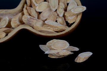 Chinese herbal medicine astragalus membranaceus on a white backg