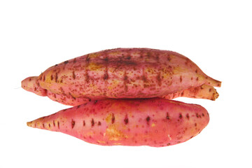 Ripe sweet potatoes on a white background