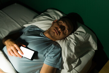 Fototapeta premium Handsome man addicted to his phone